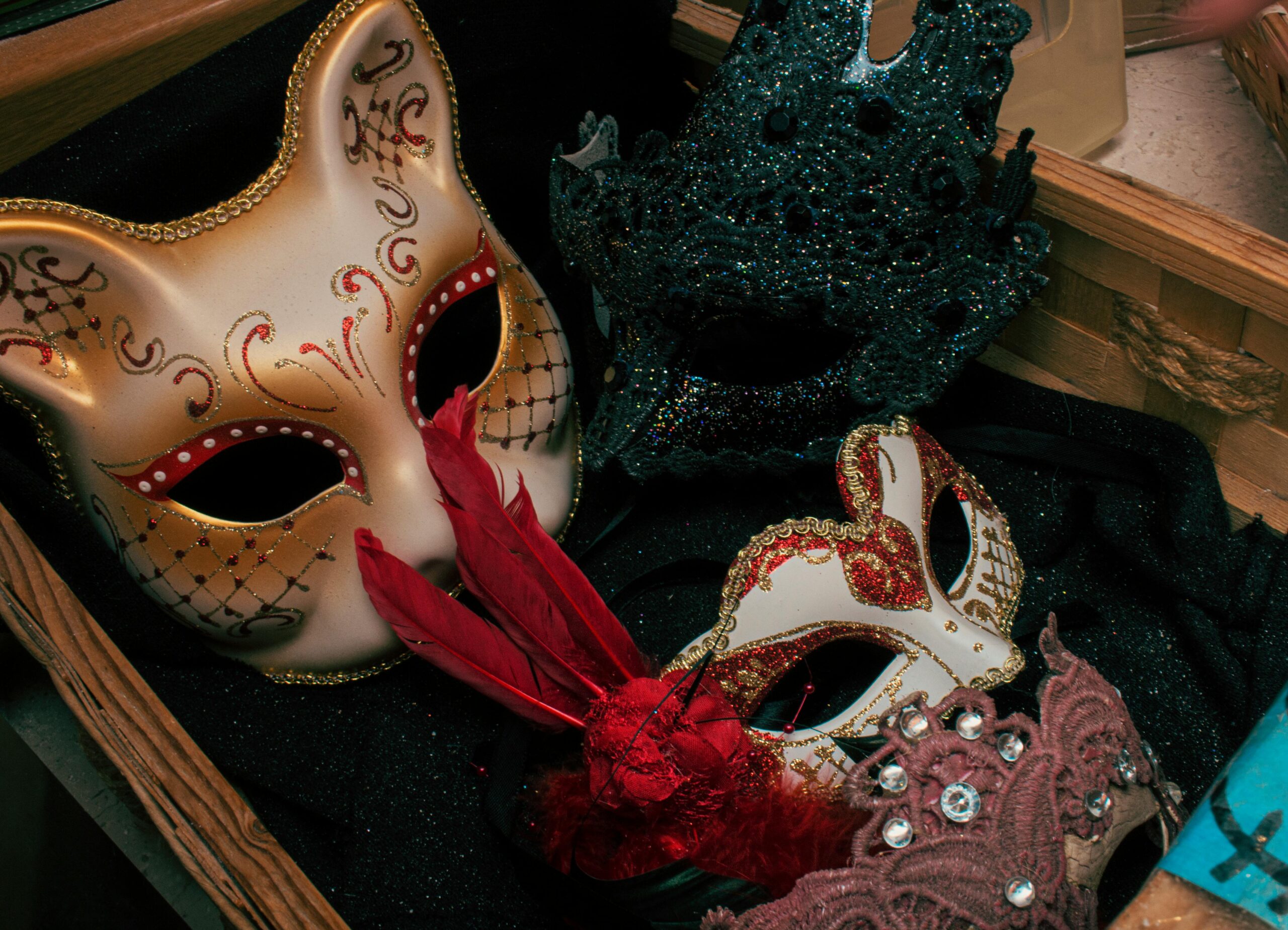A box filled with various masks and assorted items, showcasing a colorful and diverse collection.