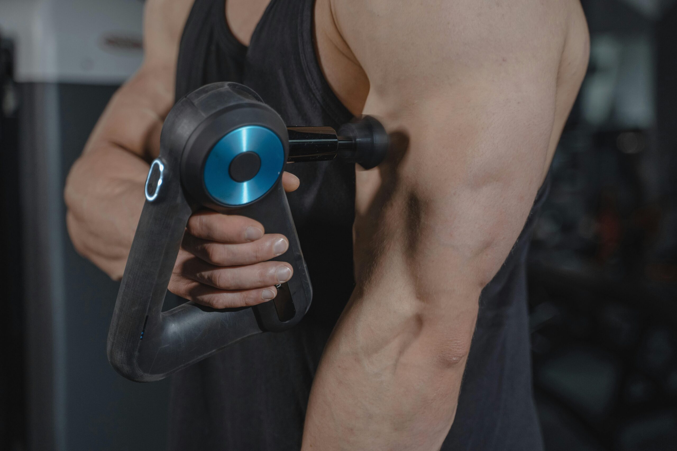 A man exercises his arm using a specialized machine designed for strength training.